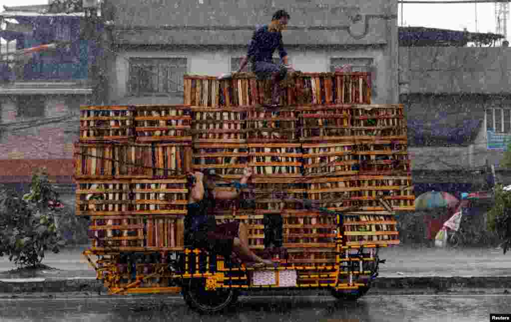Vendors ride on a vehicle transporting crates containing bananas in Malabon, Metro Manila, Philippines.