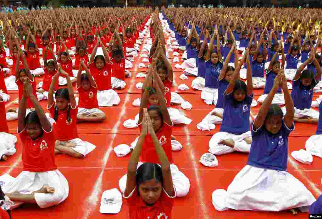 Students practice yoga on the lawn of their school ahead of International Day of Yoga, in Chennai, India. The Day of Yoga will be celebrated on June 21.