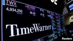 FILE - Time Warner shares are projected on a acreen above the floor of the New York Stock Exchange, New York, U.S.