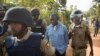 FILE - Uganda's main opposition leader Kizza Besigye, center, is arrested by police and thrown into the back of a blacked-out police van which whisked him away and was later seen at a rural police station, outside his home in Kasangati, Uganda Monday, Feb. 22, 2016.