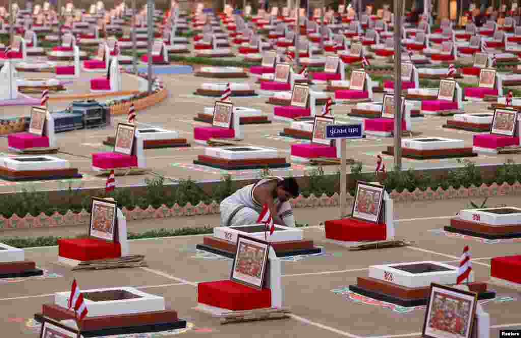 A Hindu priest decorates a &quot;havan kund&quot; or a sacred pit in which fire is lit and offerings are made, ahead of the five-day long mass prayer meetings for world peace at a temple on the outskirts of Ahmedabad, India.