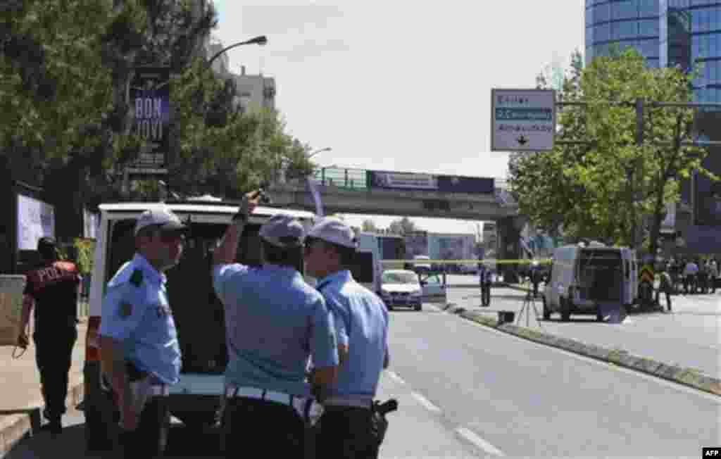 Security members and forensic experts work at the scene after a bomb exploded at a bus stop during rush hour in Istanbul, Turkey, Thursday, May 26, 2011. Seven people were injured as several ambulances rushed to the scene on a multi-lane thoroughfare in a