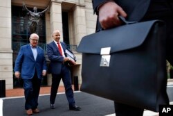 Jay Nanavati, second from left, one of the lawyers for former Donald Trump campaign chairman Paul Manafort, leaves federal court after attending the Manafort trial in Alexandria, Virginia, Aug. 7, 2018.
