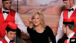 Entertainer Bette Midler, center, gestures as she poses with dancers during a news conference at the Caesars Palace in Las Vegas, May 3, 2007.