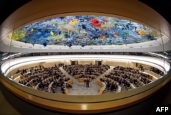 FILE - The United Nations Human Rights Council attends a presentation of a report by the Commission of Inquiry on Syria, on March 13, 2018, in Geneva.