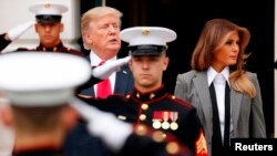 FILE - U.S. President Donald Trump and first lady Melania Trump are seen during an arrival ceremony at the South Portico of the White House in Washington, Oct. 11 2017. Trump will be hosting the leaders of Estonia, Latvia and Lithuania at the White House 