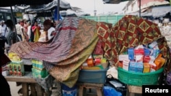 FILE - A street vendor sells illegal and false drugs in a street of Adjame in Abidjan, Ivory Coast, Oct. 13, 2018. 