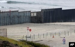 Concertina wire partially lines the border wall separating Tijuana, Mexico, behind, and San Diego, Nov. 19, 2018, in San Diego.