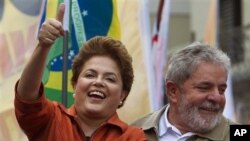 Brazil's President Luiz Inacio Lula da Silva, right, smiles as Workers Party presidential candidate Dilma Rousseff gestures to supporters during a campaign rally in Sao Bernardo do Campo, outskirts of Sao Paulo, Brazil, Saturday, Oct. 2, 2010. Brazil will