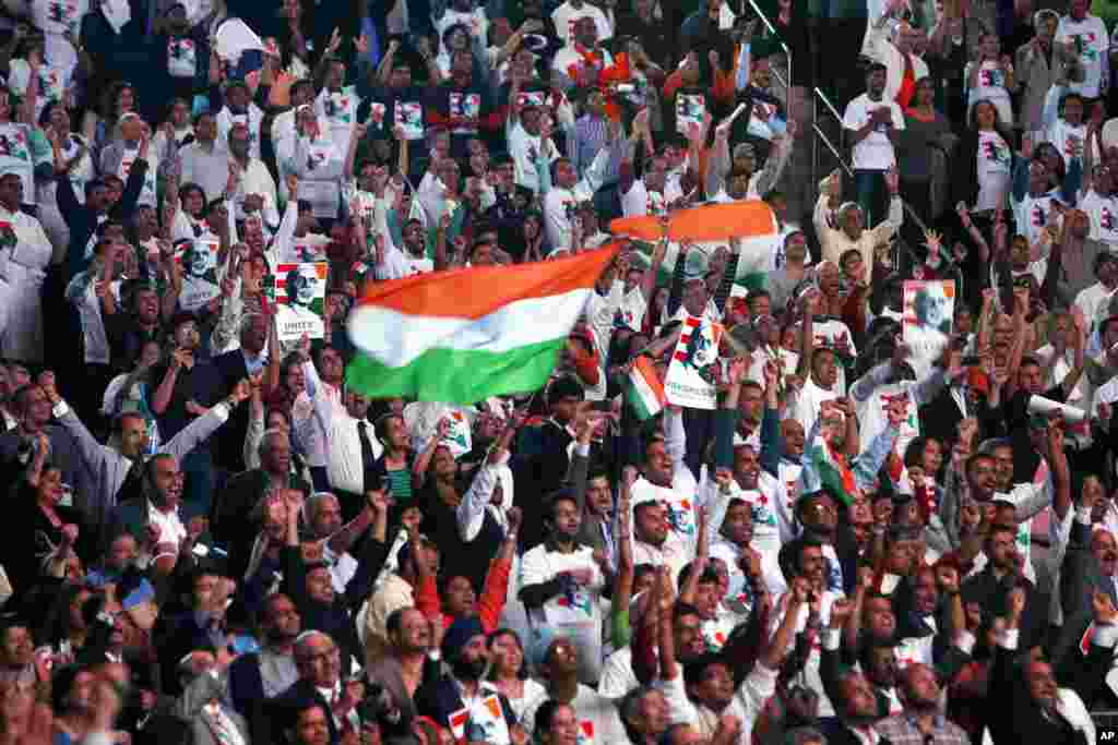 Supporters cheer and wave Indian flags as India&#39;s Prime Minister Narendra Modi gives a speech during a reception by the Indian community in honor of his visit to the United States, at Madison Square Garden, New York, Sept. 28, 2014. 