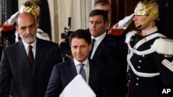 Giuseppe Conte, center, arrives to address the media after meeting Italian President Sergio Mattarella, at the Quirinale presidential palace in Rome, May 23, 2018.