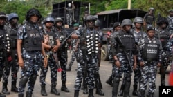 FILE - Police officers stand guard in Lagos, Nigeria, Aug. 9, 2024. Nigerian police said 20 medical students, a doctor and six other captives were rescued from their captors unharmed in central Benue State on Aug. 23.