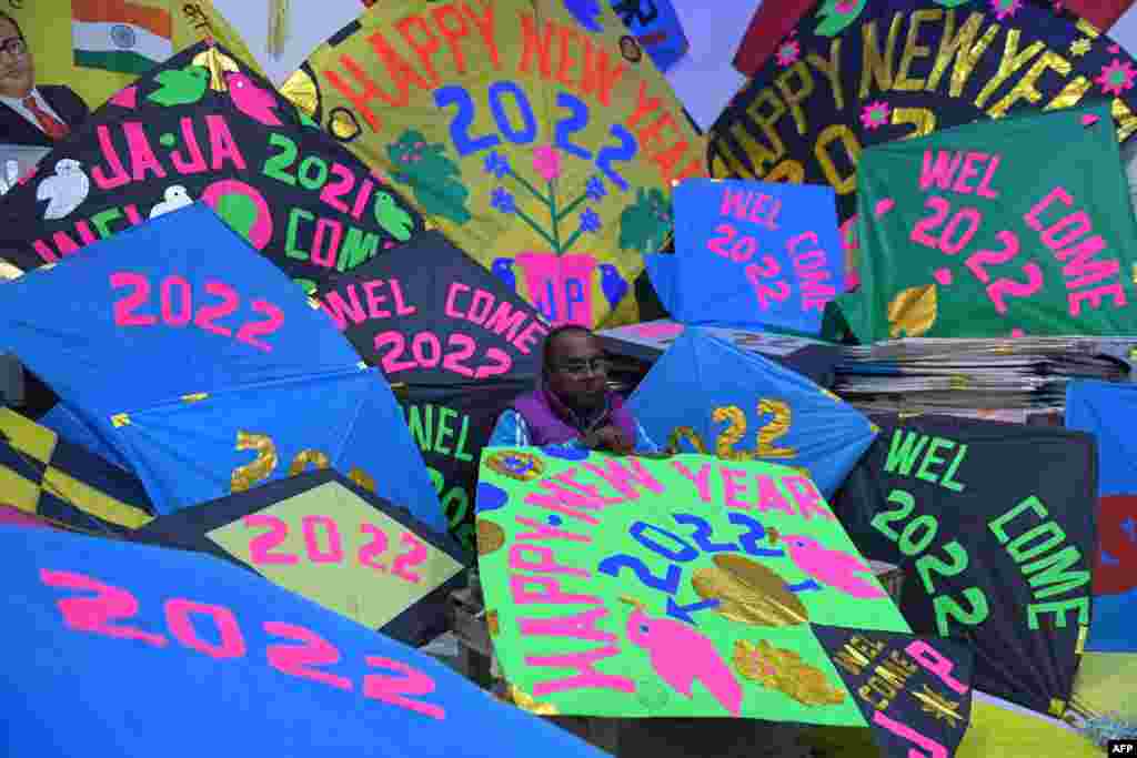 A kite maker prepares kites in his workshop ahead of the New Year celebrations on the outskirts of Amritsar, India.
