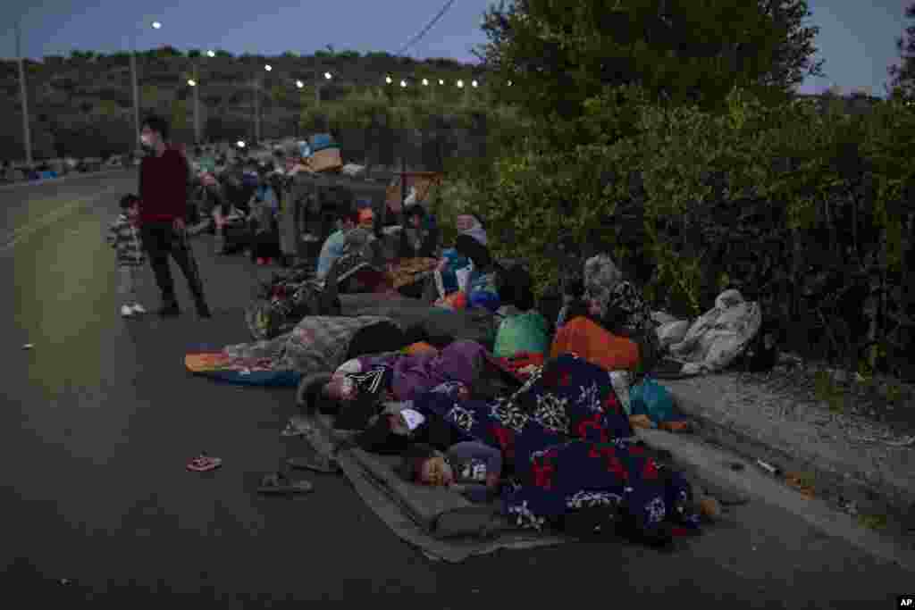 Migrants sleep on the road near the Moria refugee camp on the northeastern island of Lesbos, Greece after&nbsp; a second fire in the camp destroyed nearly everything.