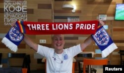 FILE - LGBT rights campaigner Di Cunningham displays a scarf during an interview with Reuters in Volgograd, Russia, June 18, 2018.