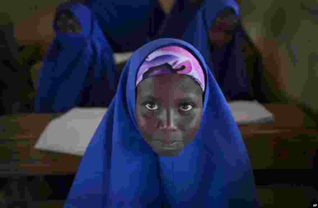 A Somali schoolgirl sits at her desk during a lesson in the town of Dhobley, currently under control by Kenyan military and Somali government forces, in Somalia Tuesday, Feb. 21, 2012.