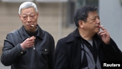 Smokers in a street in Shanghai, China, March 22, 2012. 