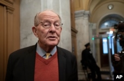 Republican Sen. Lamar Alexander of Tennessee, talks to reporters as he arrives at the Capitol for the impeachment trial of President Donald Trump on charges of abuse of power and obstruction of Congress, in Washington, Jan. 31, 2020.