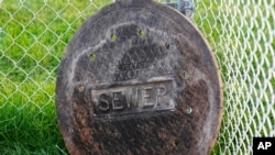 A sewer manhole cover is shown near Davis Hall at Utah State University, Sept. 2, 2020, in Logan, Utah.