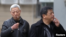FILE - Smokers in a street in Shanghai, China, March 22, 2012. 