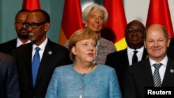 German Chancellor Angela Merkel, center, German Finance Minister Olaf Scholz, right, International Monetary Fund (IMF) Managing Director Christine Lagarde and heads of states of African countries pose for a family photo ahead of the 'G20 Compact with Africa' summit at t