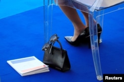 FILE - The handbag of Brigitte Macron, wife of French President Emmanuel Macron, is seen as she attends the traditional Bastille Day military parade on the Champs-Elysees Avenue in Paris, July 14, 2018. (REUTERS)