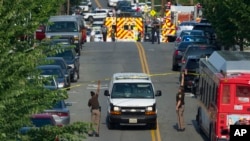Police and emergency personnel are seen near the scene where House Majority Whip Steve Scalise of La. was shot during a Congressional baseball practice in Alexandria, Va., Wednesday, June 14, 2017. 