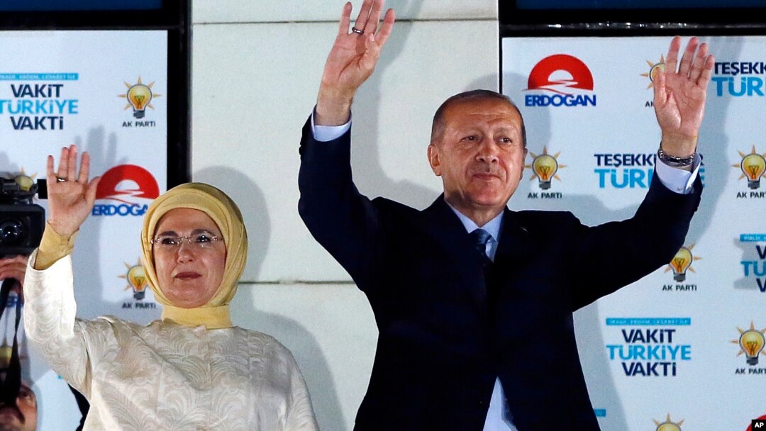 Turkey's President Recep Tayyip Erdogan (R) accompanied by his wife Emine waves to supporters of his ruling Justice and Development Party (AKP) in Ankara, Turkey, June 25, 2018. 