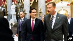 House Majority Leader Eric Cantor (r), walks with Rep. Doug Collins, after the final votes of the week in the House, June 12, 2014.