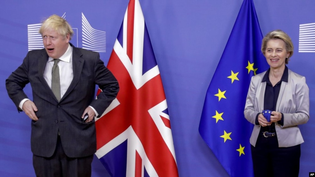 European Commission President Ursula von der Leyen, right, welcomes British Prime Minister Boris Johnson prior to a meeting at EU headquarters in Brussels, Wednesday, Dec. 9, 2020.