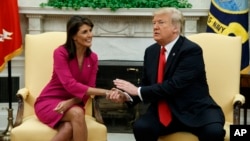 FILE — President Donald Trump meets with outgoing U.S. Ambassador to the United Nations Nikki Haley in the Oval Office of the White House, Oct. 9, 2018, in Washington.