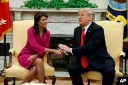 President Donald Trump meets with outgoing U.S. Ambassador to the United Nations Nikki Haley in the Oval Office of the White House, Oct. 9, 2018, in Washington.
