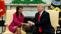 President Donald Trump meets with outgoing U.S. Ambassador to the United Nations Nikki Haley in the Oval Office of the White House, Oct. 9, 2018, in Washington. 