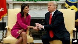 President Donald Trump meets with outgoing U.S. Ambassador to the United Nations Nikki Haley in the Oval Office of the White House, Oct. 9, 2018, in Washington. 