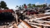 Para pekerja membersihkan puing-puing pasca badai Helene, di Cedar Key, Florida. (AP)&nbsp;