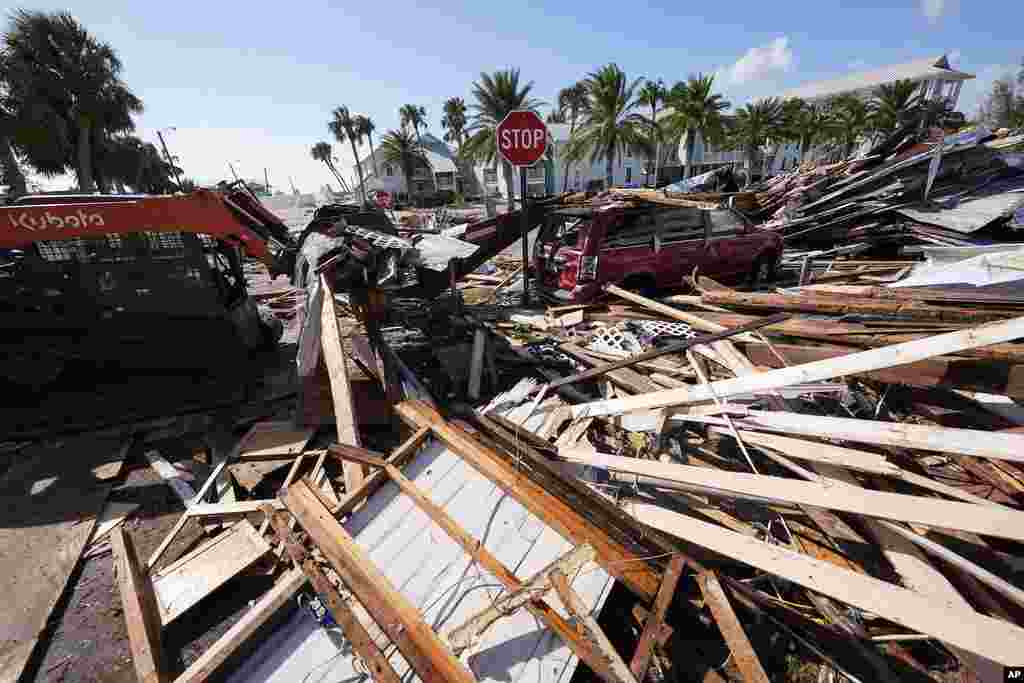 Workers clear damage in the aftermath of Hurricane Helene, in Cedar Key, Florida.