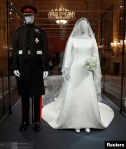 The wedding outfits of Meghan, Duchess of Sussex, and Harry, Duke of Sussex, are on display ahead of the exhibition A Royal Wedding, soon to open at Windsor Castle, in Windsor, Britain, Oct. 25, 2018.