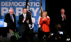 FILE - Democratic presidential candidates, from left, Bernie Sanders, Martin O'Malley, Hillary Clinton and Lincoln Chafee stand on stage during the Iowa Democratic Party's Hall of Fame Dinner in Cedar Rapids, Iowa, July 17, 2015.