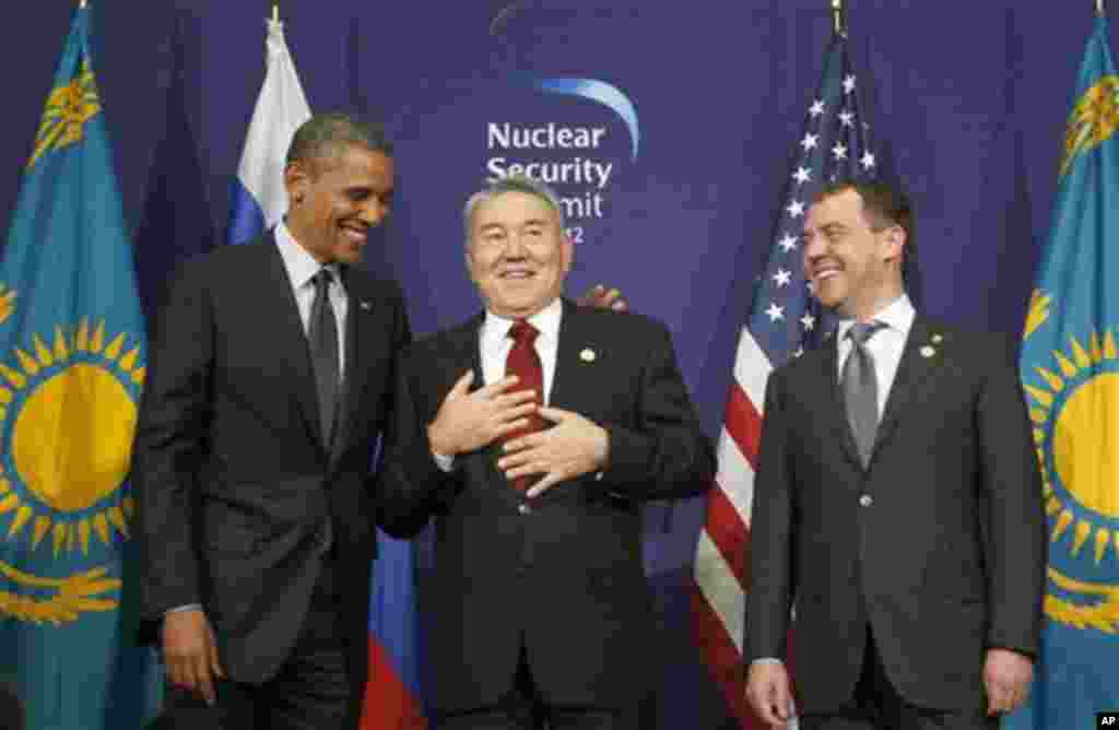 U.S. President Barack Obama, left, laughs with Kazakhstan President Nursultan Nazarbayev, center, and Russian President Dmitry Medvedev during their joint statement at the Nuclear Security Summit at the Coex Center, in Seoul, South Korea, Tuesday, March 2