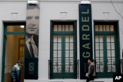People walk in front of the Carlos Gardel museum in Buenos Aires, Argentina, July 5, 2017.