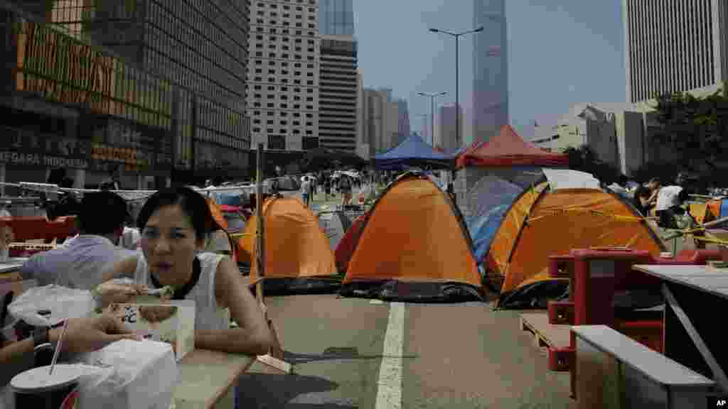 A woman eats her lunch in an occupied area outside government headquarters in Hong Kong's Admiralty district, Oct. 20, 2014. 