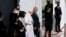 Pope Francis, center, walks with Iraqi President Barham Salih towards his plane upon concluding his visit to Iraq at Baghdad airport, Iraq, Monday, March 8, 2021. 