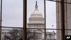 The Capitol is seen framed through a window in the Cannon House Office Building on Capitol Hill in Washington, Feb. 13, 2025.