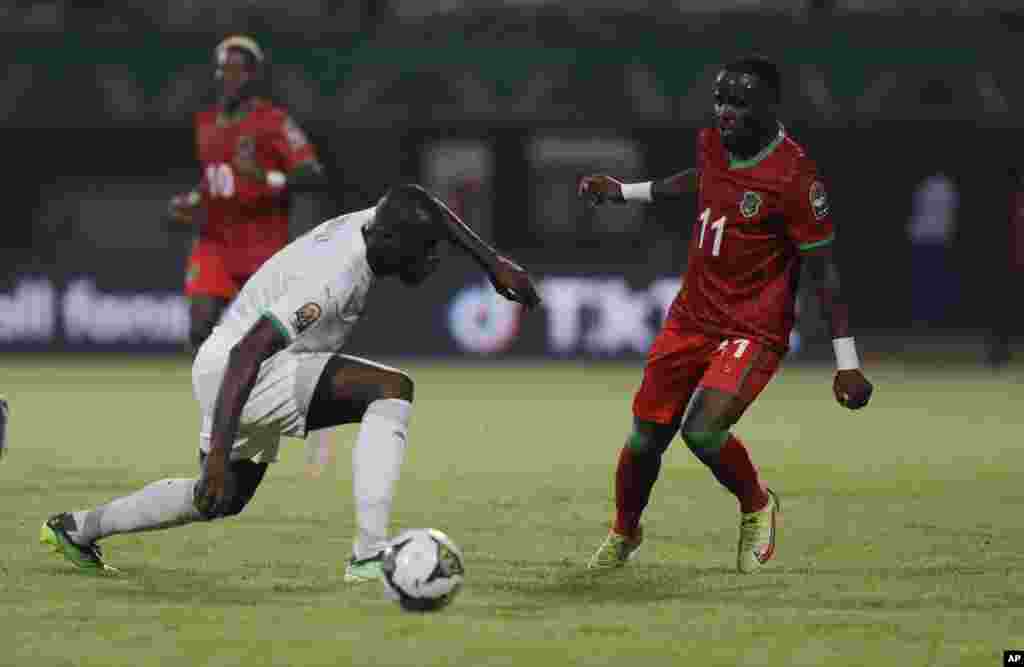 Senegal&#39;s Kalidou Koulibaly, left, is challenged by Malawi&#39;s Gabadinho Mhango during the soccer match between Malawi and Senegal; Cameroon, Jan. 18, 2022.