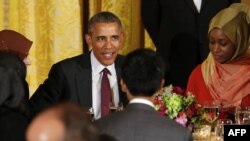 U.S. President Barack Obama talks to guests during an Iftar dinner celebrating Ramadan in the State Dining Room at the White House in Washington, D.C. on June 22, 2015.