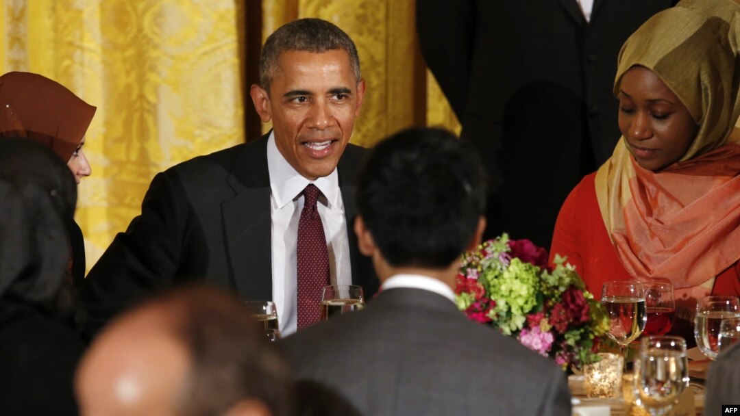 U.S. President Barack Obama talks to guests during an Iftar dinner celebrating Ramadan in the State Dining Room at the White House in Washington, D.C. on June 22, 2015.