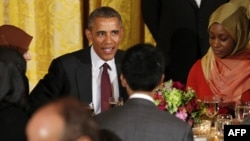 U.S. President Barack Obama talks to guests during an Iftar dinner celebrating Ramadan in the State Dining Room at the White House in Washington, D.C. on June 22, 2015.