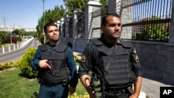 FILE - Police patrol outside Iran's parliament building, in Tehran, Iran, June 7, 2017.