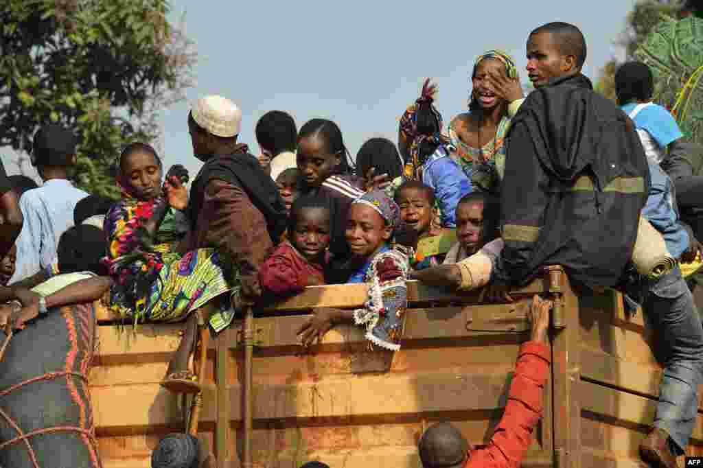 Chadian civilians sit on a Chadian military truck in the PK12 district of Bangui to flee the Central African Republic and return to Chad.