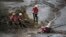 Rescue workers take a rest from their search for victims at the town of Bento Rodrigues, after a dam burst on Thursday, in Minas Gerais state, Brazil, Nov. 8, 2015.
